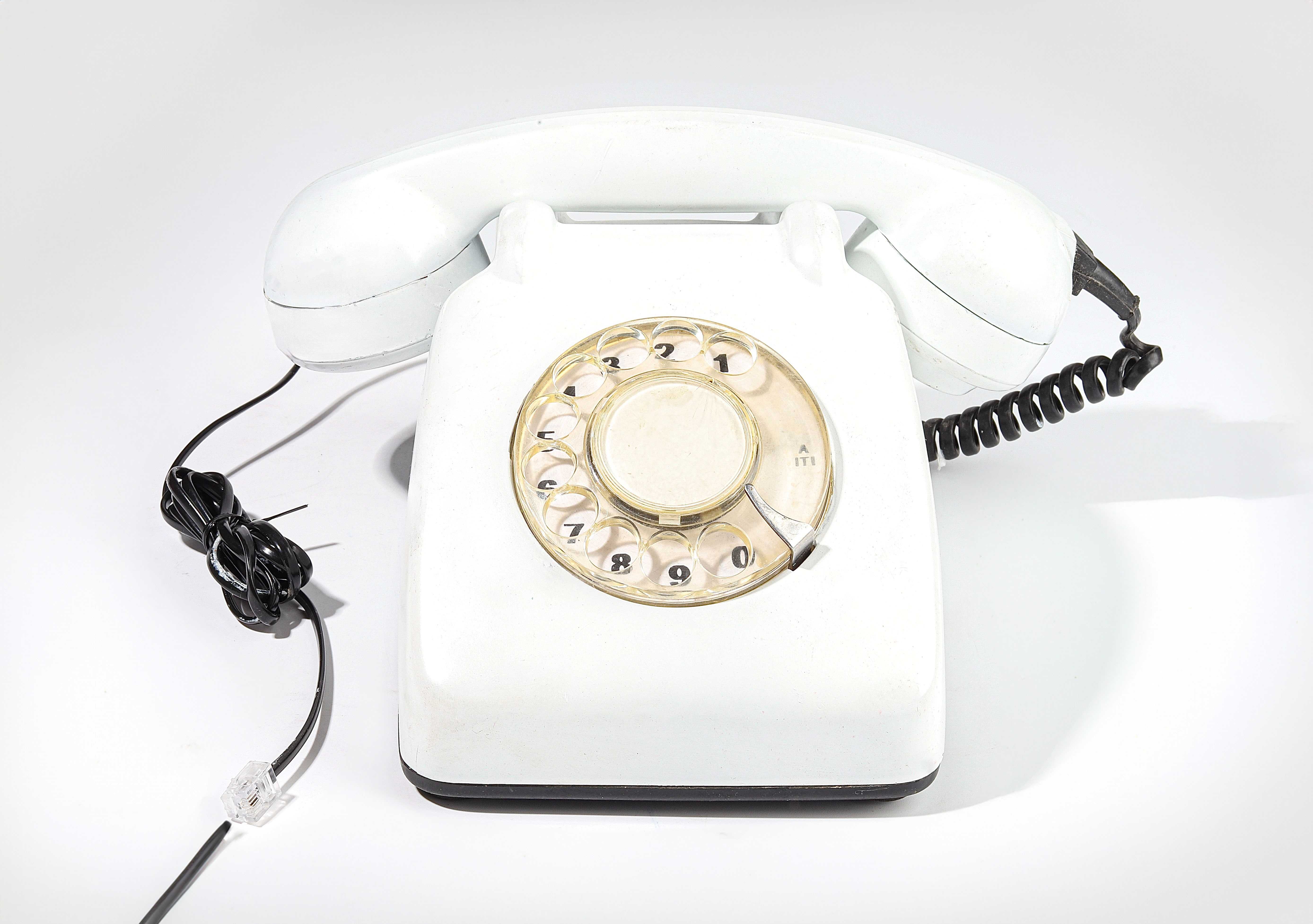 Antique telephones of different shapes and sizes